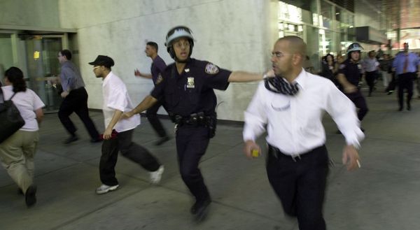 People run as the top of one of the World Trade Center towers collapses after two planes crashed into the North and South towers on 11 September 2001, in New York. - Sputnik International