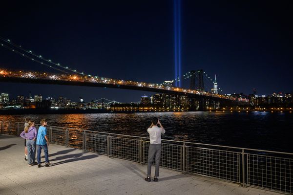 People take photos from the Brooklyn waterfront of a light installation entitled "Tribute in Light" commemorating the 9/11 terrorist attacks, in New York on 10 September 2021. People take photos from the Brooklyn waterfront of a light installation entitled "Tribute in Light" commemorating the 9/11 terrorist attacks, in New York on 10 September 2021. - Sputnik International