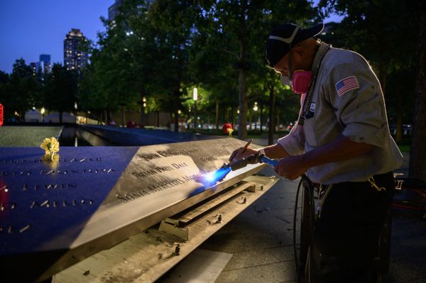 A worker cleans a display showing the names of the lives lost in the 9/11 terrorist attacks before a reflecting pool at the 9/11 memorial in New York on 10 September 2021. A worker cleans a display showing the names of the lives lost in the 9/11 terrorist attacks before a reflecting pool at the 9/11 memorial in New York on 10 September 2021. - Sputnik International