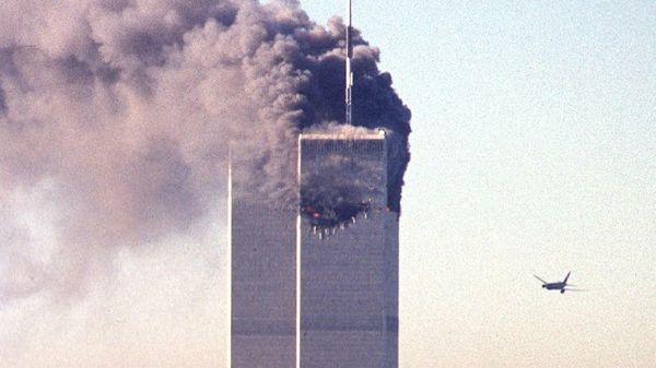 (FILES) In this file photo taken on September 11, 2001, a hijacked commercial aircraft approaches the twin towers of the World Trade Center shortly before crashing into the landmark skyscraper in New York.  - Sputnik International