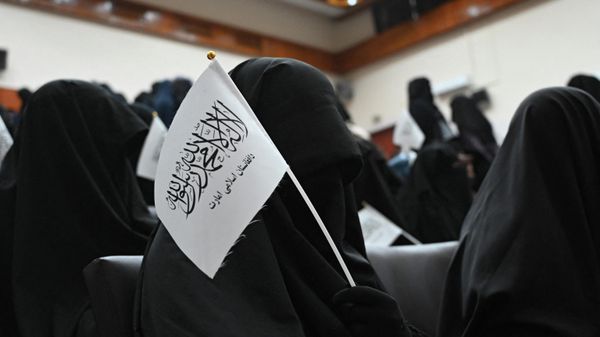 Veiled students hold Taliban flags as they listen a speaker before a pro-Taliban rally at the Shaheed Rabbani Education University in Kabul on September 11, 2021. - Sputnik International
