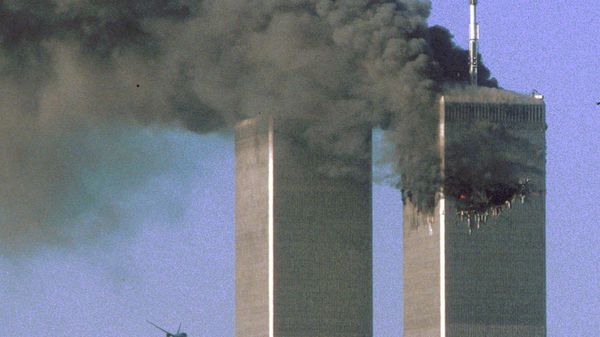 Hijacked United Airlines Flight 175 flies toward the World Trade Center twin towers shortly before slamming into the South tower (L), as the North tower burns, following an earlier attack by a hijacked airliner in New York, U.S., September 11, 2001 - Sputnik International