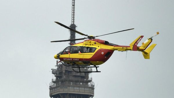 An EC145 helicopter of the French Civil Defence (Securite Civile) flies next to the Eiffel Tower during the annual Bastille Day military parade on the Champs-Elysees avenue in Paris on July 14, 2021. (Photo by Bertrand GUAY / AFP) - Sputnik International