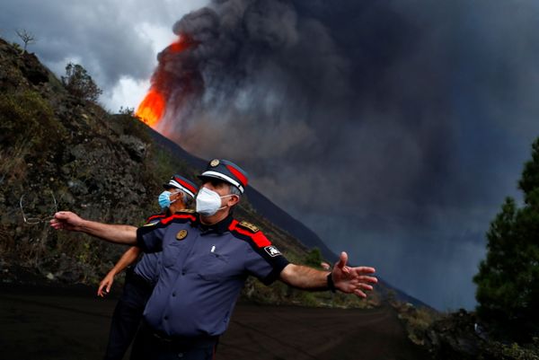 Police officers block a road as lava rises after the eruption of a volcano on the Island of La Palma, Canary Islands. - Sputnik International