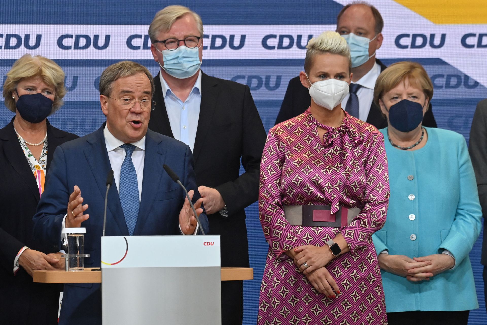 The Christian Democratic Union (CDU) leader and Chancellor candidate Armin Laschet (L) addresses the audience on stage at the CDU headquarters after the estimates were broadcast on television in Berlin on 26 September 2021 after the German general elections. Right is a board member of Germany's conservative Christian Democratic Union (CDU) party Silvia Breher and German Chancellor Angela Merkel.  - Sputnik International, 1920, 27.09.2021