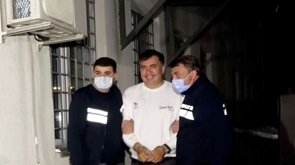 Georgia's former President Mikheil Saakashvili, who was detained after returning to the country, is escorted by police officers as he arrives at a prison in Rustavi, Georgia October 1, 2021, in this still image taken from video. - Sputnik International