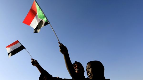 Sudanese wave their national flag as they gather at freedom square during the first anniversary of the start of the uprising that toppled long-time ruler Omar al-Bashir, in Khartoum, Sudan December 19, 2019.  - Sputnik International