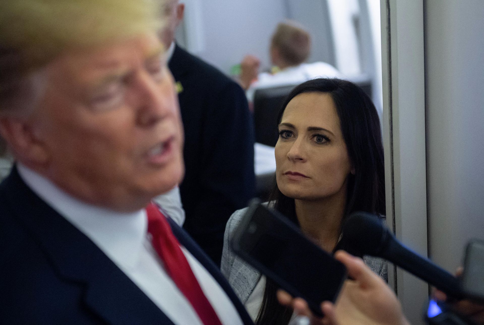 In this file photo former White House Press Secretary Stephanie Grisham listens as US President Donald Trump speaks to the media aboard Air Force One while flying between El Paso, Texas and Joint Base Andrews in Maryland, August 7, 2019. - An aide dubbed the Music Man was tasked with playing calming tunes for Donald Trump when he went into rages, according to a scandal-filled book by a former press secretary.Stephanie Grisham, notorious for not giving a single televised press conference while serving as Trump's chief spokeswoman, writes in I'll Take Your Questions Now that her boss went into terrifying rants.The former president and his wife Melania have vociferously condemned the book, excerpts of which appeared on September 28, 2021 in The New York Times and Washington Post. In this file photo former White House Press Secretary Stephanie Grisham listens as US President Donald Trump speaks to the media aboard Air Force One while flying between El Paso, Texas and Joint Base Andrews in Maryland, August 7, 2019. - An aide dubbed the Music Man was tasked with playing calming tunes for Donald Trump when he went into rages, according to a scandal-filled book by a former press secretary.Stephanie Grisham, notorious for not giving a single televised press conference while serving as Trump's chief spokeswoman, writes in I'll Take Your Questions Now that her boss went into terrifying rants.The former president and his wife Melania have vociferously condemned the book, excerpts of which appeared on September 28, 2021 in The New York Times and Washington Post. - Sputnik International, 1920, 06.10.2021
