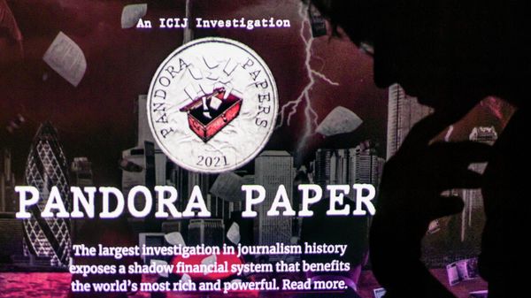 This photograph illustration shows a woman's shadow cast on the logo of Pandora Papers, in Lavau-sur-Loire, western France, on October 4, 2021 - Sputnik International