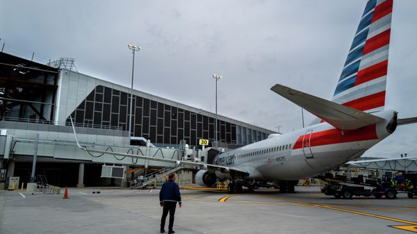 Christopher Rhoads, Manager of Airport Operations/Aviation at LaGuardia Airport in New York, stands near an American Airlines passenger jet being served at gate 30, Wednesday, March 24, 2021, near newer construction at the airport, part of a multi-year, multi-billion dollar project that will modernize almost the entirety of the airport's departure and arrival terminals. - Sputnik International