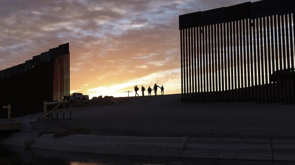 In this Thursday, June 10, 2021, file photo, a pair of migrant families from Brazil pass through a gap in the border wall to reach the United States after crossing from Mexico to Yuma, Ariz., to seek asylum. - Sputnik International