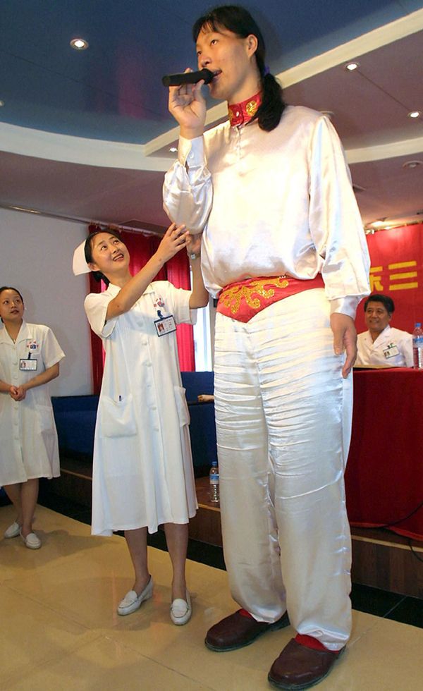 China's Yao Defen at 230cm (7ft 6in) was recognised by the Guinness World Records as the world's tallest woman until she died 13 November 2012. Here she is on 18 May 2002 thanking doctors and nurses at the Sanjiu hospital in the southern Chinese city of Guangzhou, where she had been undergoing treatment to halt her growth. - Sputnik International