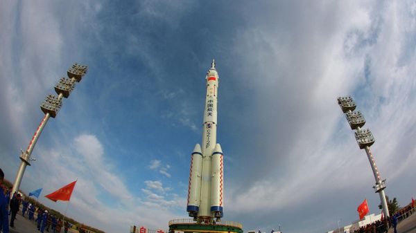 This photo taken on October 7, 2021 shows a Long March-2F carrier rocket, carrying the Shenzhou-13 spacecraft, being transported to the launching area at the Jiuquan Satellite Launch Centre in the country's northwestern Gansu province. - Sputnik International