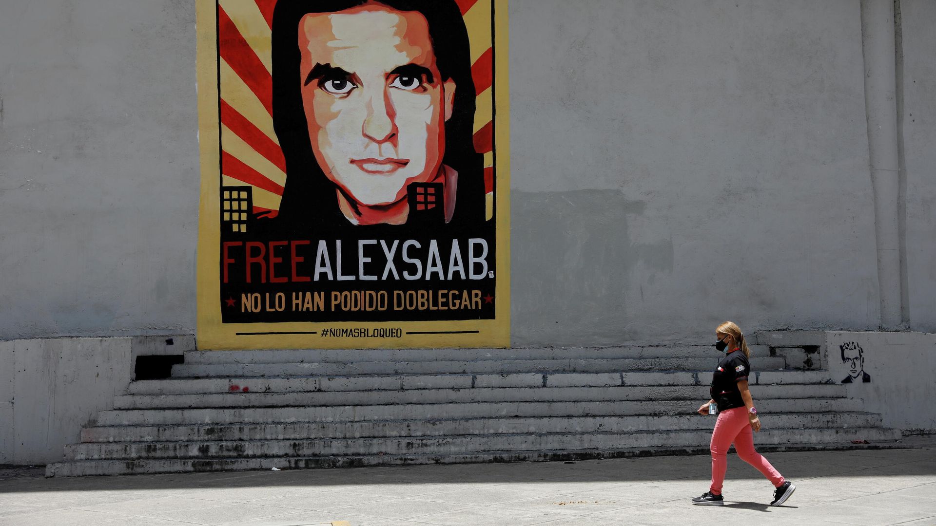 A woman walks by a mural in support of the liberation of businessman Alex Saab, who was detained in Cape Verde on charges of laundering money for the government of Venezuelan President Nicolas Maduro, in Caracas A woman walks by a mural in support of the liberation of businessman Alex Saab, who was detained in Cape Verde on charges of laundering money for the government of Venezuelan President Nicolas Maduro, in Caracas - Sputnik International, 1920, 16.10.2021