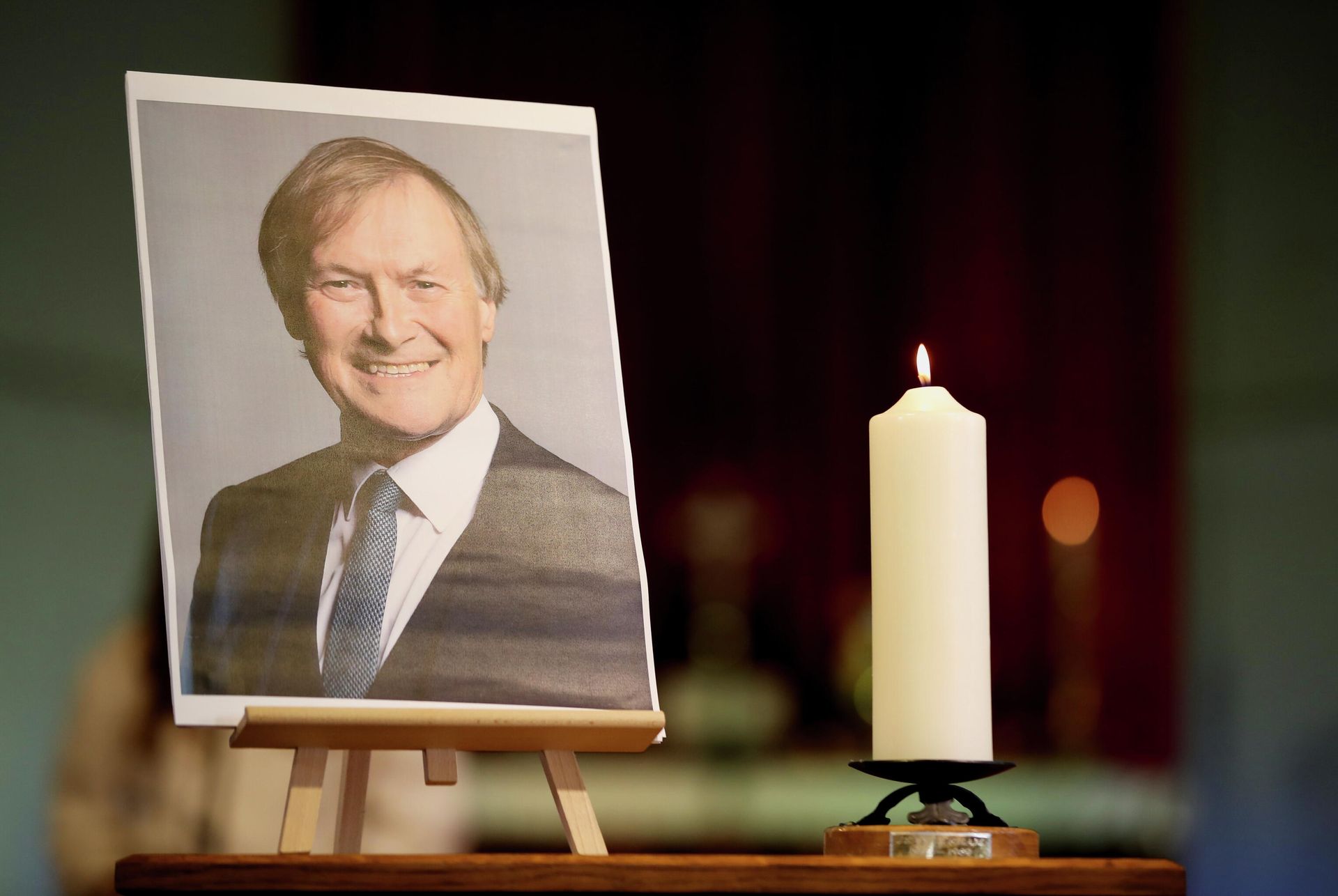A candle and a portrait of British MP David Amess are seen at the church of St Michael's and all Angels, in Leigh-on-Sea A candle and a portrait of British MP David Amess are seen at the church of St Michael's and all Angels, in Leigh-on-Sea - Sputnik International, 1920, 20.10.2021
