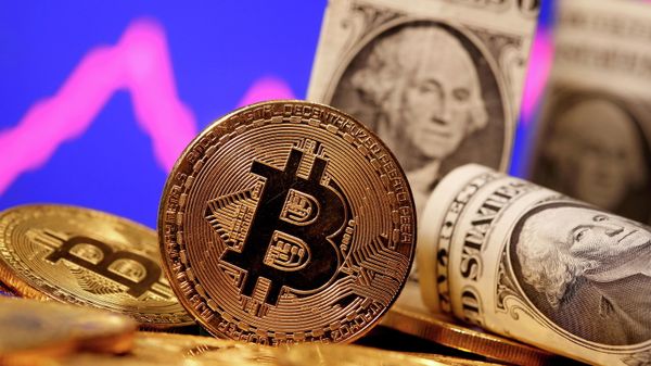 A representation of virtual currency Bitcoin and U.S. One Dollar banknotes are seen in front of a stock graph in this illustration taken January 8, 2021 - Sputnik International