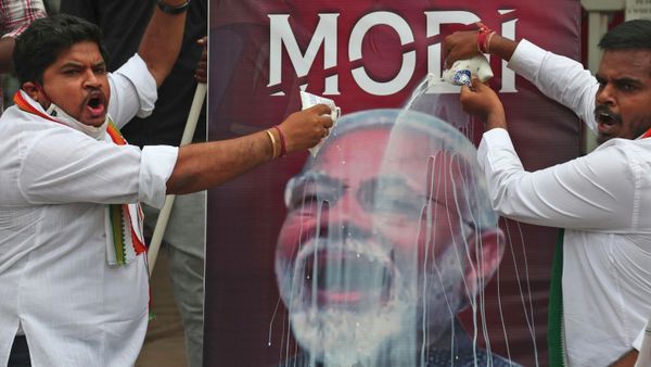 FILE - In this Friday, June 11, 2021 file photo, activists of India's opposition Congress party pour milk over a poster of Indian Prime Minister Narendra Modi, to mockingly celebrate fuel price reaching the century mark, during a protest against the hike of petrol and diesel price in Hyderabad, India.  - Sputnik International