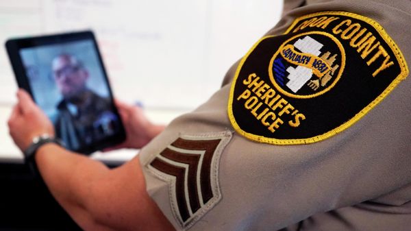 In this Friday, Aug. 13, 2021, photo Sheriff's Police Sgt. Bonnie Busching tests a virtual meeting with a tablet at the Cook County Sheriff's Office in Chicago. The Cook County Sheriff's Office has started putting people having a crisis face to face with mental health professionals before they lash out at deputies or try to harm themselves and to do it they're taking a page out of countless businesses forced hold their meeting virtually. - Sputnik International
