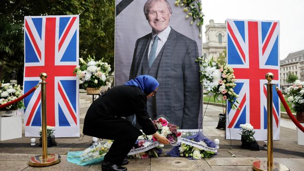 Members of the Anglo-Iranian community and supporters of the National Council of Resistance of Iran (NCRI) attend a memorial service to pay tribute to  slain British lawmaker David Amess in Parliament Square in front of the Houses of Parliament in central London on October 18, 2021 - Sputnik International