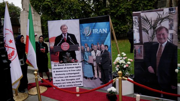 Images of British Member of Parliament David Amess are displayed opposite the Houses of Parliament in London, placed there as a memorial by supporters of the National Council of Resistance of Iran (NCRI), Monday, Oct. 18, 2021 - Sputnik International