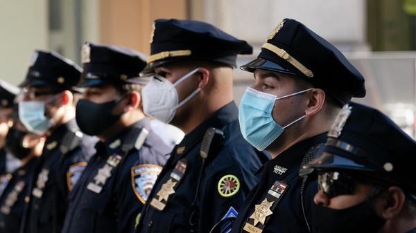 In this Oct. 5, 2020, file photo, New York Police Department officers in masks stand during a service at St. Patrick's Cathedral in New York to honor 46 colleagues who have died due to COVID-19 related illness. - Sputnik International