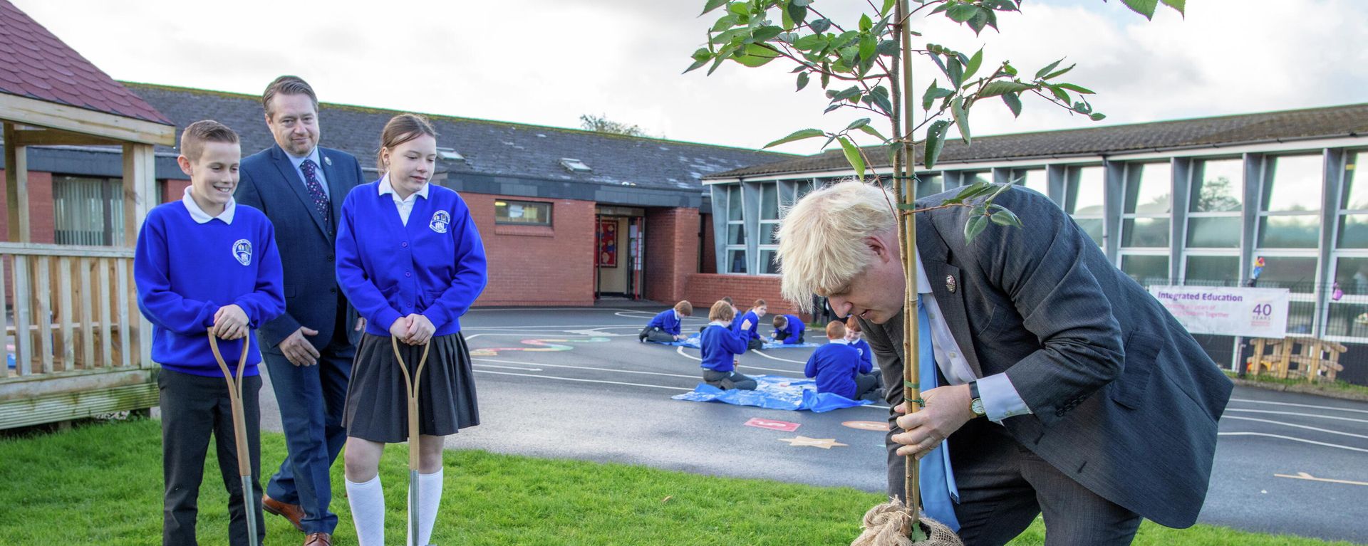 Britain's Prime Minister Boris Johnson plants a tree during a visit to Crumlin Integrated Primary School in County Antrim Britain's Prime Minister Boris Johnson plants a tree during a visit to Crumlin Integrated Primary School in County Antrim - Sputnik International, 1920, 25.10.2021