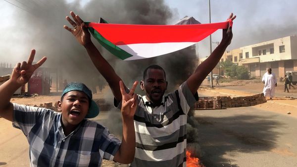 A protester waves a flag during what the information ministry calls a military coup in Khartoum, Sudan, October 25, 2021 - Sputnik International