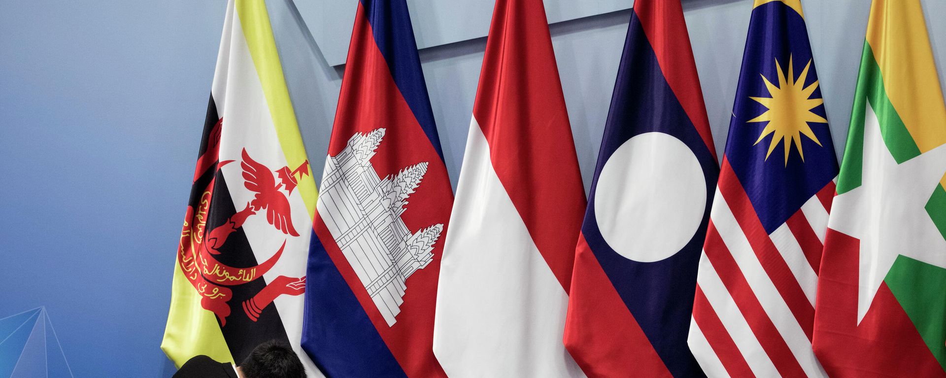 In this Nov. 13, 2018, file photo, a worker adjusts the Brunei Darussalam flag prior the 22nd ASEAN coordinating council meeting on the sidelines of the 33rd ASEAN summit in Singapore. China is hosting foreign ministers from 10 Southeast Asian nations amid heightened competition between Beijing and Washington for influence in the region. In this Nov. 13, 2018, file photo, a worker adjusts the Brunei Darussalam flag prior the 22nd ASEAN coordinating council meeting on the sidelines of the 33rd ASEAN summit in Singapore. China is hosting foreign ministers from 10 Southeast Asian nations amid heightened competition between Beijing and Washington for influence in the region. - Sputnik International, 1920, 25.10.2022