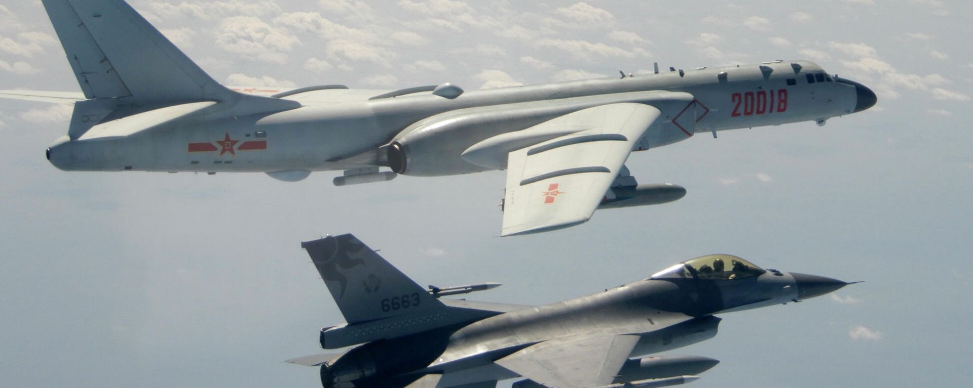In this Feb. 10, 2020, file photo and released by the Republic of China (ROC) Ministry of National Defense, a Taiwanese Air Force F-16 in foreground flies on the flank of a Chinese People's Liberation Army Air Force (PLAAF) H-6 bomber as it passes near Taiwan In this Feb. 10, 2020, file photo and released by the Republic of China (ROC) Ministry of National Defense, a Taiwanese Air Force F-16 in foreground flies on the flank of a Chinese People's Liberation Army Air Force (PLAAF) H-6 bomber as it passes near Taiwan - Sputnik International, 1920, 03.03.2023