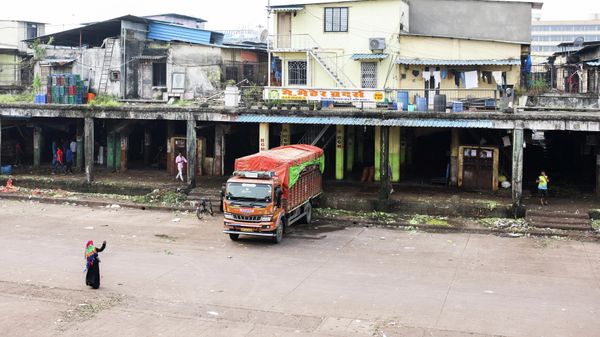 A woman walks inside a deserted wholesale market, that was shut during a Maharashtra statewide strike, after people were killed in clashes when a car linked to a federal minister ran over farmers protesting against controversial farm laws in Uttar Pradesh earlier this month, in Navi Mumbai, India October 11, 2021 - Sputnik International