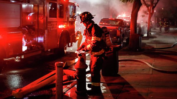 Firefighters put out a fire in a vehicle near which lay a box of spent fireworks, Wednesday, July 1, 2020, in the Bedford-Stuyvesant neighborhood of the Brooklyn borough of New York. (AP Photo/John Minchillo) - Sputnik International