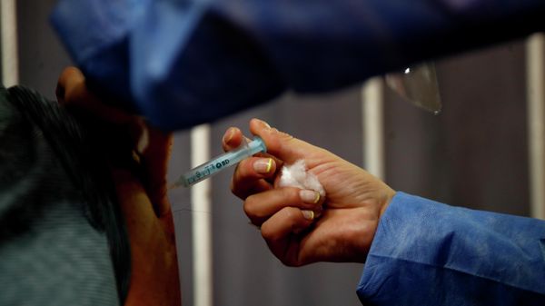 A nurse gives a shot of Russia's Sputnik V vaccine for COVID-19 to a health worker inside River Plate stadium in Buenos Aires, Argentina, Tuesday, Feb. 2, 2021. - Sputnik International