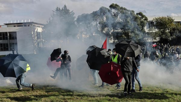 Demonstrators stand amidst tear gas fired by riot police as they protest against hard-right political talk-show star Eric Zemmour's book signing event in Nantes, western France, Saturday, Oct. 30, 2021. - Sputnik International
