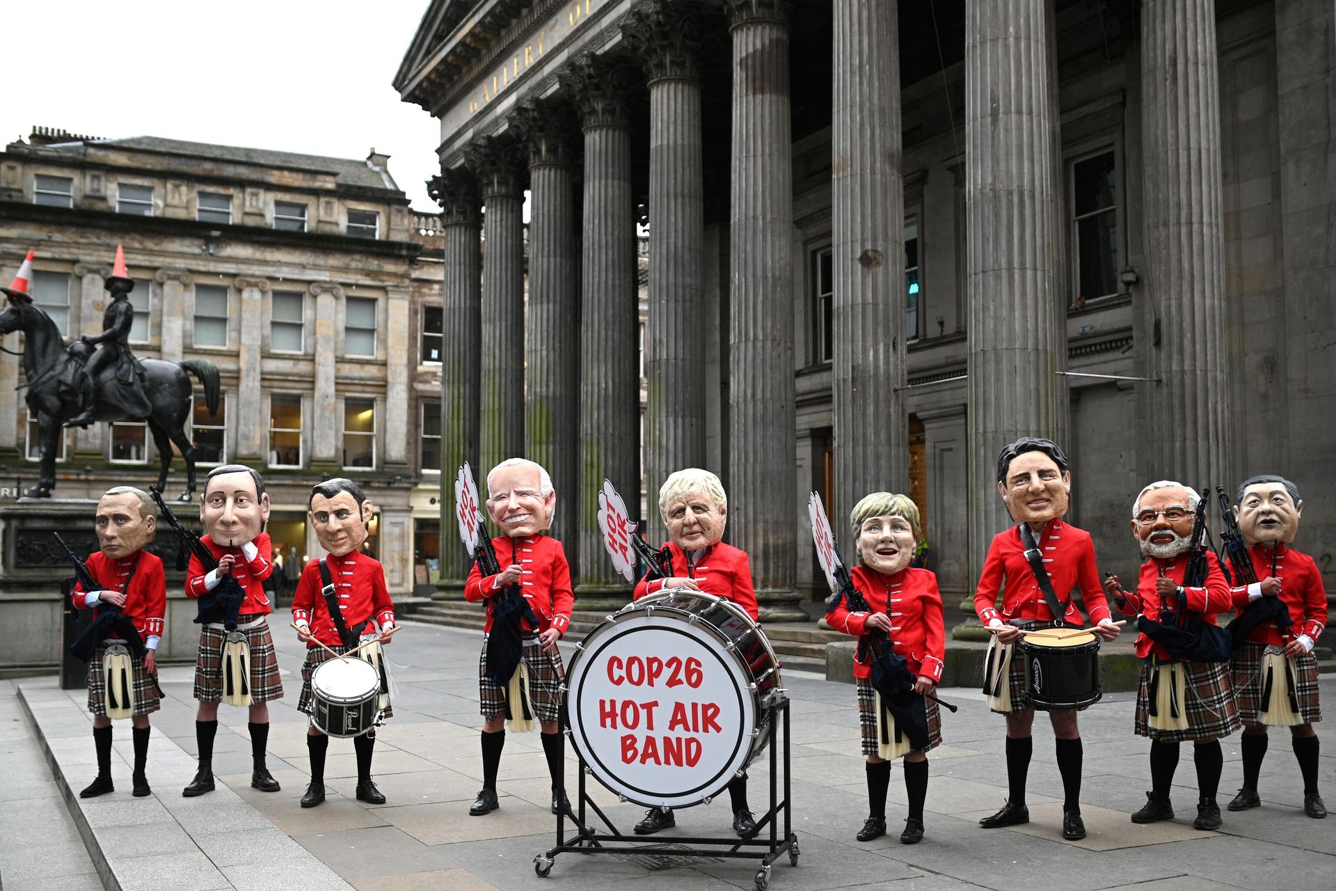 Oxfam activists dressed as a Scottish pipe band and representing (L-R) Russian President Vladimir Putin, Italian Prime Minister Mario Draghi, French President Emmanuel Macron, US President Joe Biden, British Prime Minister Boris Johnson, Germany's Chancellor Angela Merkel, Canadian Prime Minister Justin Trudeau, India's Prime Minister Narendra Modi and Chinese President Xi Jinping pose during their Big Heads protest stunt at the Royal Exchange Square in Glasgow on November 1, 2021 on the sidelines of the COP26 UN Climate Summit. Oxfam activists dressed as a Scottish pipe band and representing (L-R) Russian President Vladimir Putin, Italian Prime Minister Mario Draghi, French President Emmanuel Macron, US President Joe Biden, British Prime Minister Boris Johnson, Germany's Chancellor Angela Merkel, Canadian Prime Minister Justin Trudeau, India's Prime Minister Narendra Modi and Chinese President Xi Jinping pose during their Big Heads protest stunt at the Royal Exchange Square in Glasgow on November 1, 2021 on the sidelines of the COP26 UN Climate Summit. - Sputnik International, 1920, 01.11.2021