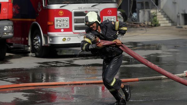 An Indian firefighter displays his skills during the annual fire drill competition in Mumbai, India, Tuesday, March. 9, 2021 - Sputnik International