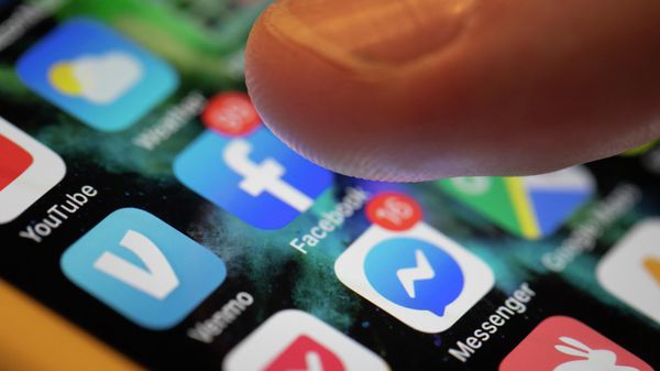 This Aug. 11, 2019, file photo an iPhone displays the apps for Facebook and Messenger in New Orleans.   - Sputnik International