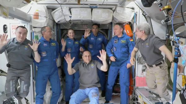 This NASA TV frame grab image captured on November 11, 2021 shows the crew of the International Space Station (L-R) Anton Shkaplerov, Tom Marshburn, Kayla Barron, Raja Chari, Matthias Maurer, Mark Vande Hei and (sitting) Pyotr Dubrov , after Crew-3 sucessfull docking.  - Sputnik International