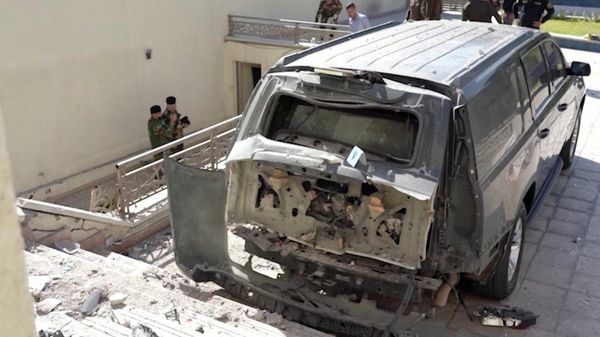 A destroyed vehicle is parked in front of Iraqi Prime Minister Mustafa al-Kadhimi's residence following an assassination attempt by an armed drone in Baghdad, Iraq in this screen grab taken from a handout video obtained by Reuters on November 7, 2021 - Sputnik International