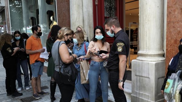 A private security employee checks customers’ vaccination certificates against the coronavirus disease (COVID-19), as the government imposed further measures for unvaccinated citizens, in Athens, Greece, November 6, 2021 - Sputnik International