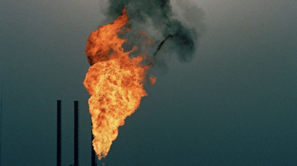 Some of the byproduct in oil production is burned off at a petrochemical plant in the desert at Abadan, near Ahwaz, Iran, during a sandstorm, July 1971 - Sputnik International