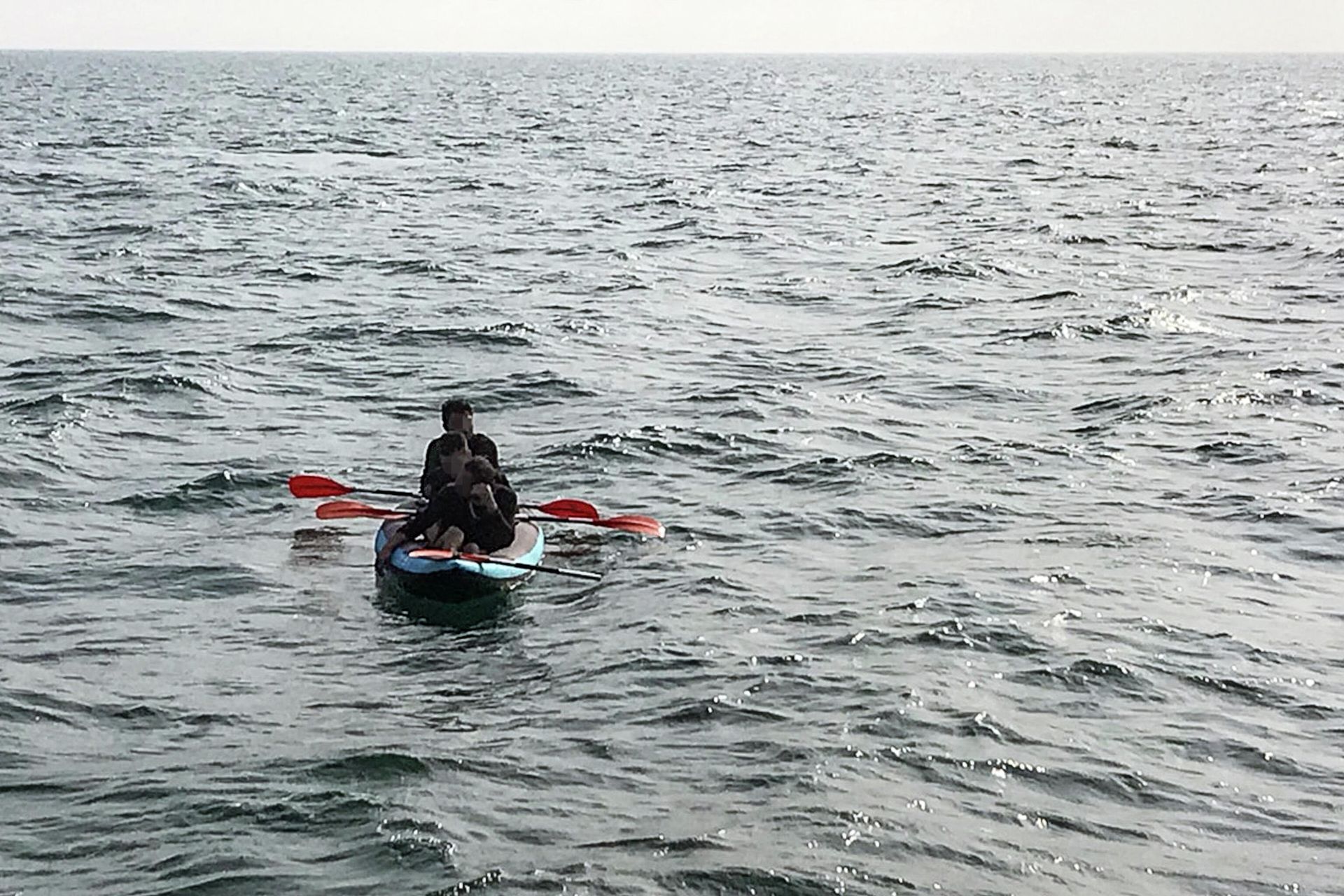 Three migrants who were attempting to cross The English Channel from France to Britain are seen as they drift in an inflatable canoe off the French coast at Calais on August 4, 2018, before being rescued by lifeguards of Les Sauveteurs en Mer (SNSM) Three migrants who were attempting to cross The English Channel from France to Britain are seen as they drift in an inflatable canoe off the French coast at Calais on August 4, 2018, before being rescued by lifeguards of Les Sauveteurs en Mer (SNSM) - Sputnik International, 1920, 03.12.2021
