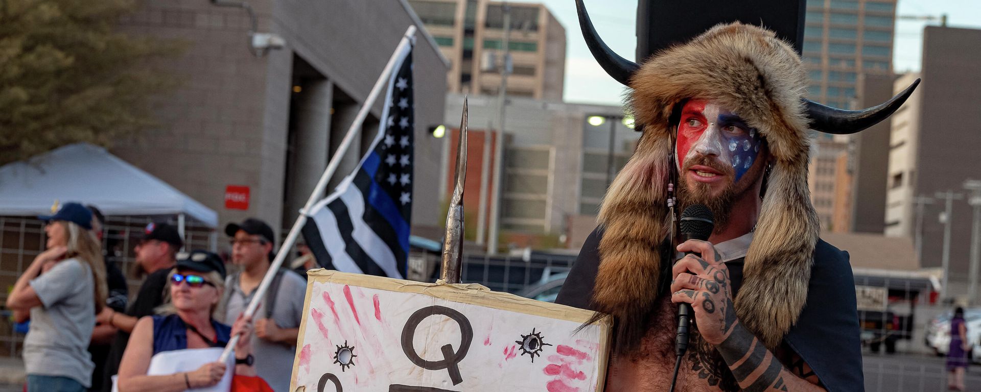 Jacob Chansley, known as the QAnon Shaman, holds a sign reading Q Sent Me as supporters of US President Donald Trump gather to protest outside the Maricopa County Election Department as counting continues after the US presidential election in Phoenix, Arizona, on November 5, 2020. Jacob Chansley, known as the QAnon Shaman, holds a sign reading Q Sent Me as supporters of US President Donald Trump gather to protest outside the Maricopa County Election Department as counting continues after the US presidential election in Phoenix, Arizona, on November 5, 2020. - Sputnik International, 1920, 06.01.2025