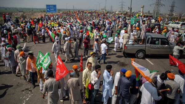 Indian farmers participate in a protest while blocking a major highway to mark 100 days of the ongoing farmer protests against new farm laws along the Delhi-Haryana border near New Delhi, India, Saturday, March 6, 2021. Thousands of farmers have hunkered down outside New Delhi’s borders since late November to voice their anger against three laws passed by Parliament last year. Prime Minister Narendra Modi’s government says the laws are necessary to modernize agriculture but farmers say they will leave them poorer and at the mercy of big corporations.  - Sputnik International