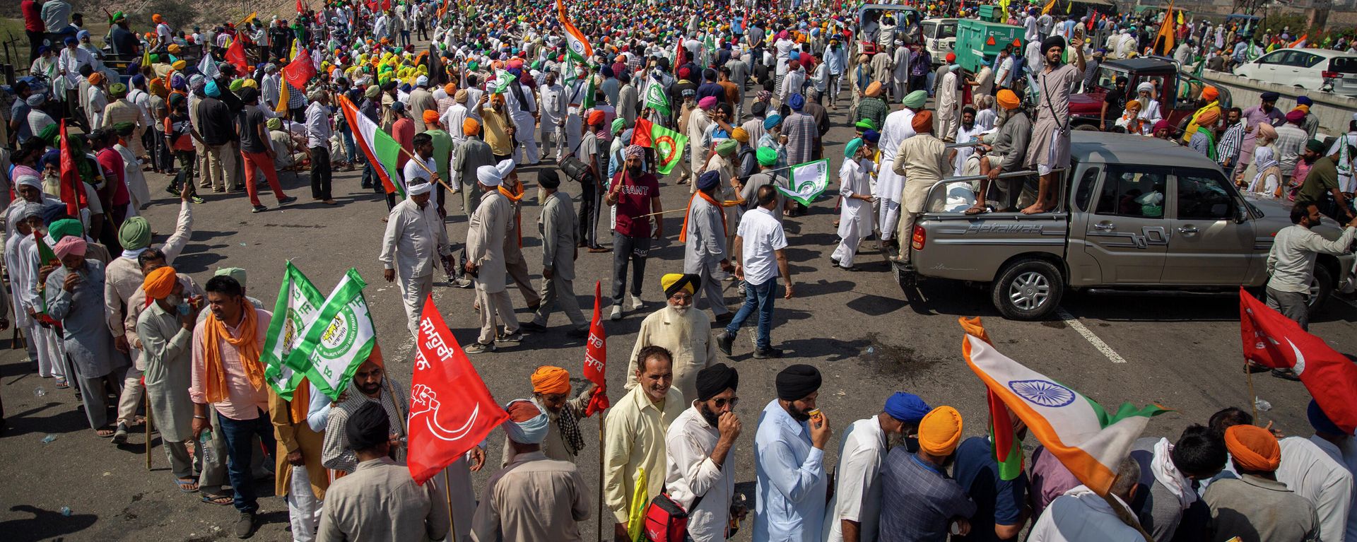 Indian farmers participate in a protest while blocking a major highway to mark 100 days of the ongoing farmer protests against new farm laws along the Delhi-Haryana border near New Delhi, India, Saturday, March 6, 2021. Thousands of farmers have hunkered down outside New Delhi’s borders since late November to voice their anger against three laws passed by Parliament last year. Prime Minister Narendra Modi’s government says the laws are necessary to modernize agriculture but farmers say they will leave them poorer and at the mercy of big corporations. Indian farmers participate in a protest while blocking a major highway to mark 100 days of the ongoing farmer protests against new farm laws along the Delhi-Haryana border near New Delhi, India, Saturday, March 6, 2021. Thousands of farmers have hunkered down outside New Delhi’s borders since late November to voice their anger against three laws passed by Parliament last year. Prime Minister Narendra Modi’s government says the laws are necessary to modernize agriculture but farmers say they will leave them poorer and at the mercy of big corporations. - Sputnik International, 1920, 19.11.2021
