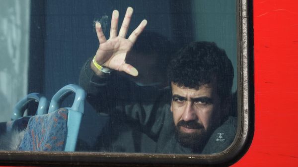 A newly arrived migrant is seen on board a bus in Dover harbour after crossing the channel in Dover, Britain, November 18, 2021 - Sputnik International