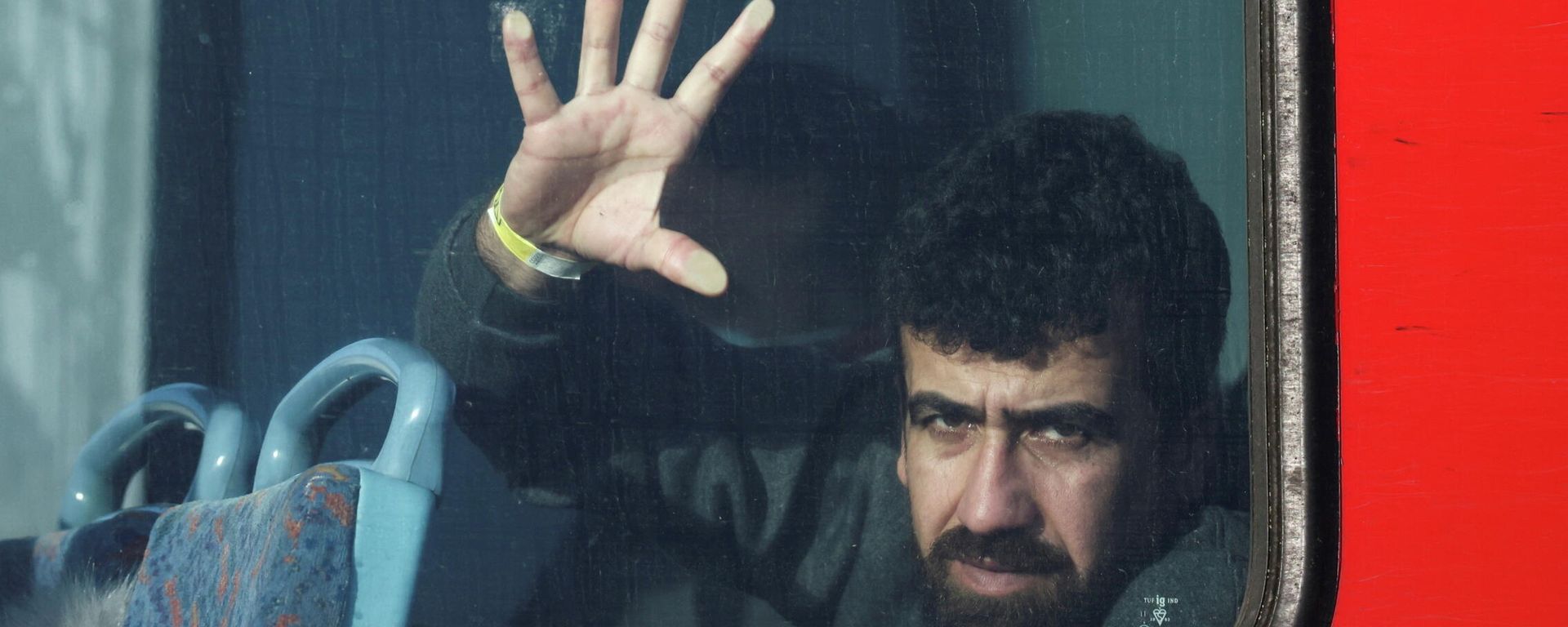 A newly arrived migrant is seen on board a bus in Dover harbour after crossing the channel in Dover, Britain, November 18, 2021 - Sputnik International, 1920, 19.11.2021