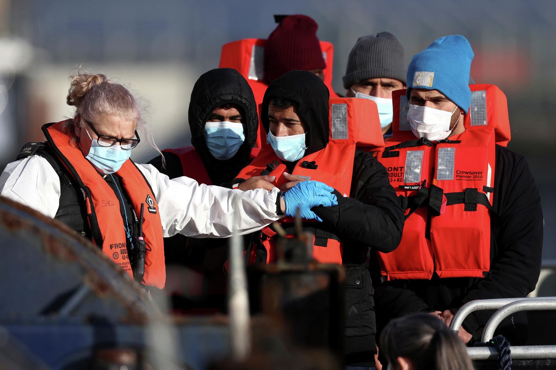 Migrants are escorted by Border Force staff into Dover harbour after crossing the channel in Dover, Britain, November 18, 2021 - Sputnik International, 1920, 19.11.2021
