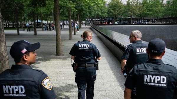 NYPD officer Michael Dougherty, a 25-year veteran, second from right, patrols with his colleagues beside the south reflecting pool of the 9/11 Memorial & Museum where names of his deceased colleagues and friends are displayed, Monday, Aug. 16, 2021, in New York.  - Sputnik International