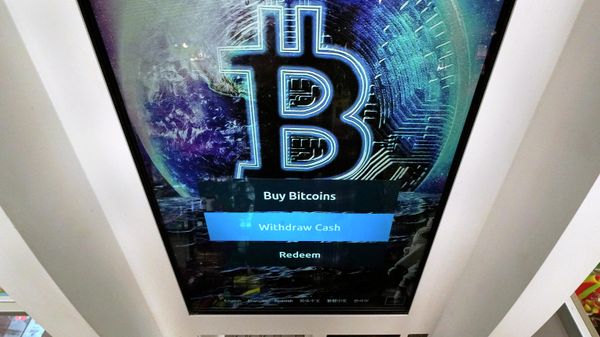 In this Feb. 9, 2021, file photo, the Bitcoin logo appears on the display screen of a cryptocurrency ATM in Salem, N.H. - Sputnik International