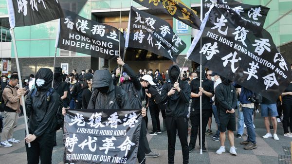 People with flags bearing Hong Kong independence slogans march in support of Save12, the campaign to save twelve Hong Kong pro-democracy activists who on August 23 were caught by mainland Chinese authorities trying to flee Hong Kong to Taiwan by boat, in central Taipei on October 25, 2020.  - Sputnik International